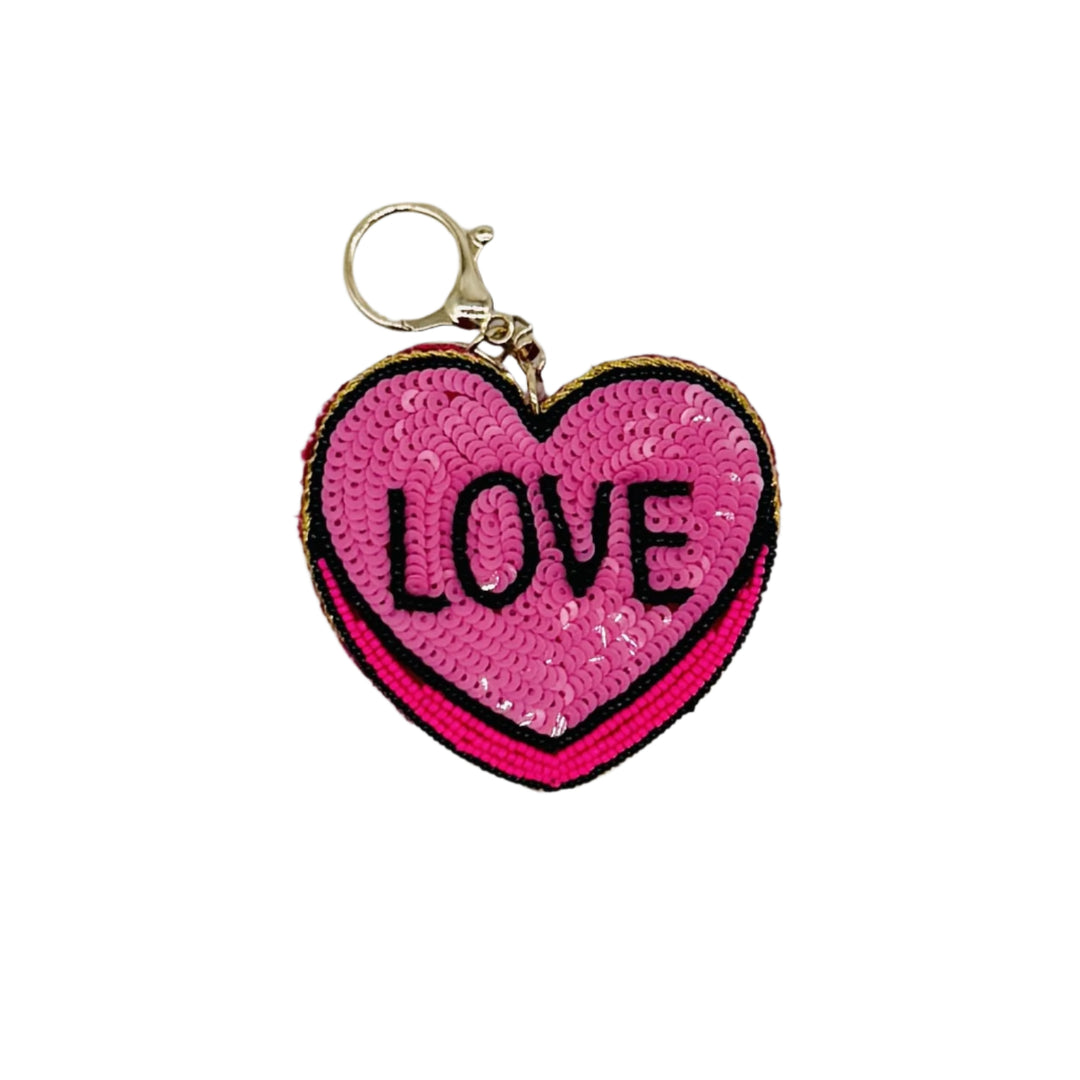 heart shaped keychain with word love on it.